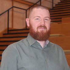 Portrait of Dr Andrew Robert Beadling- Co-Investigator at FractureFix Dr Andrew Robert Beadling stands for a portrait in front of wooden stairs